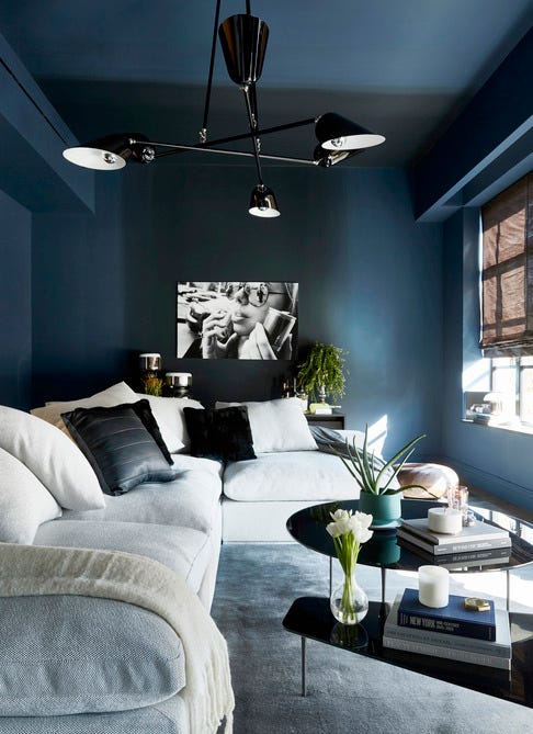 for an ombré effect, an entertainment room was painted in farrow ball’s stiffey blue and railings sofa by designlush chandelier by zia priven