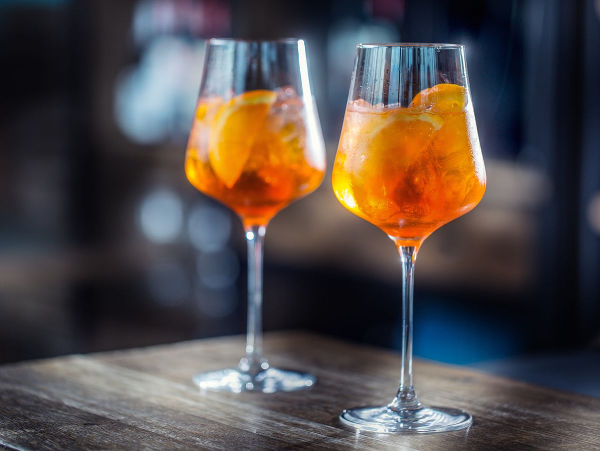https://hips.hearstapps.com/hmg-prod/images/aperol-spritz-drink-on-bar-counter-in-pub-or-royalty-free-image-922744284-1566242655.jpg?crop=0.88847xw:1xh;center,top&resize=1200:*