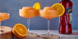 blended aperol spritz with an orange wheel garnish