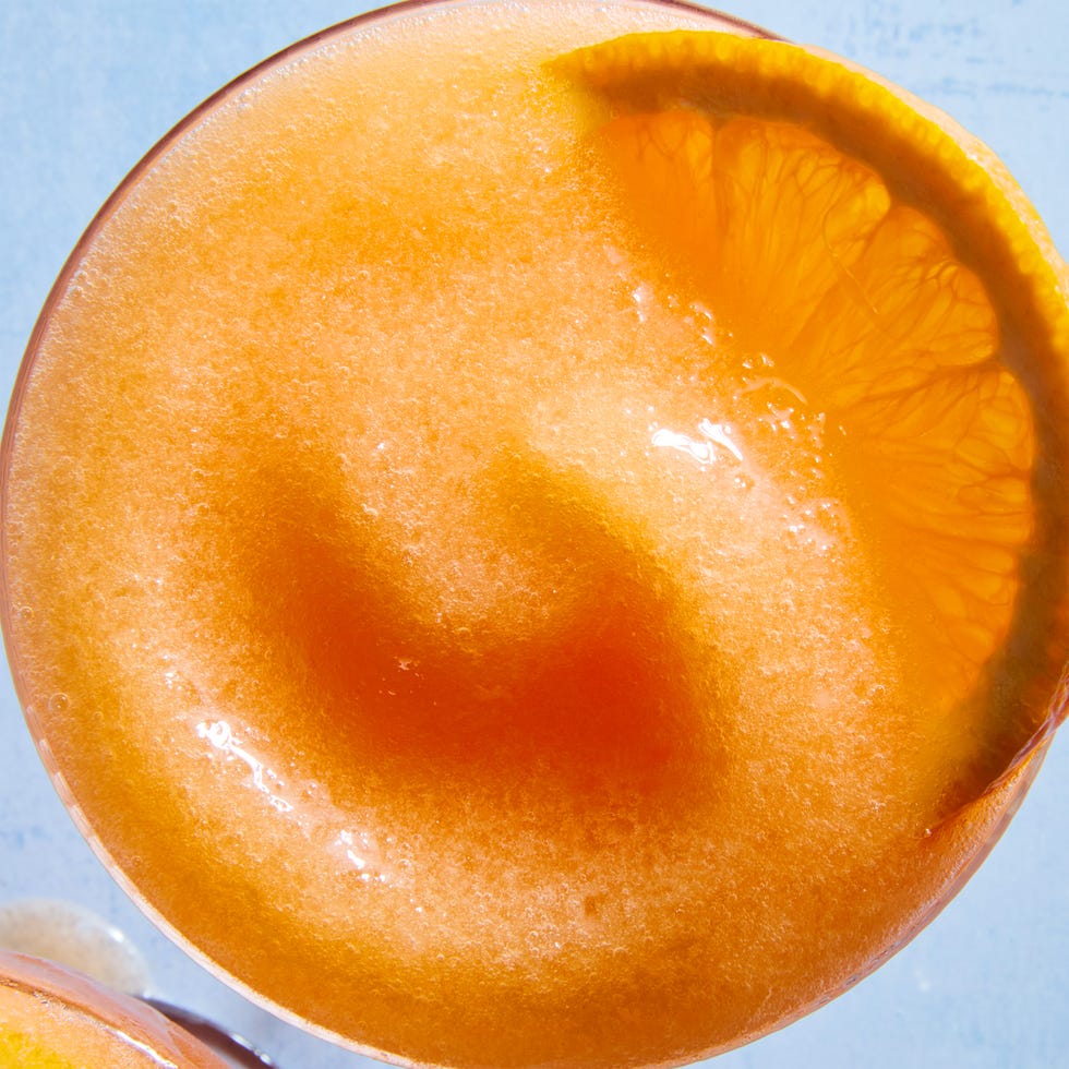 blended aperol spritz with an orange wheel garnish