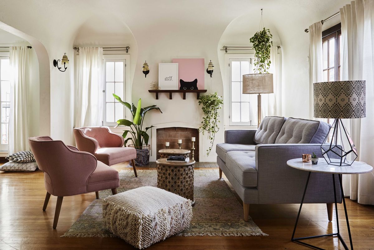 white living room, white curtains, gray couch with pink lounge chairs