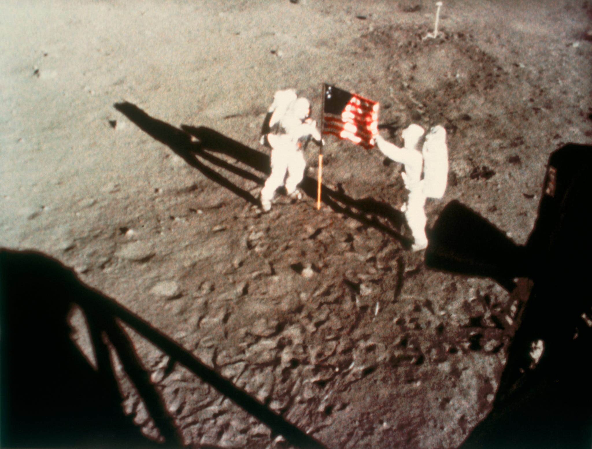 Astronauts Armstrong and Aldrin unfurling the US flag on the Moon, 1969.