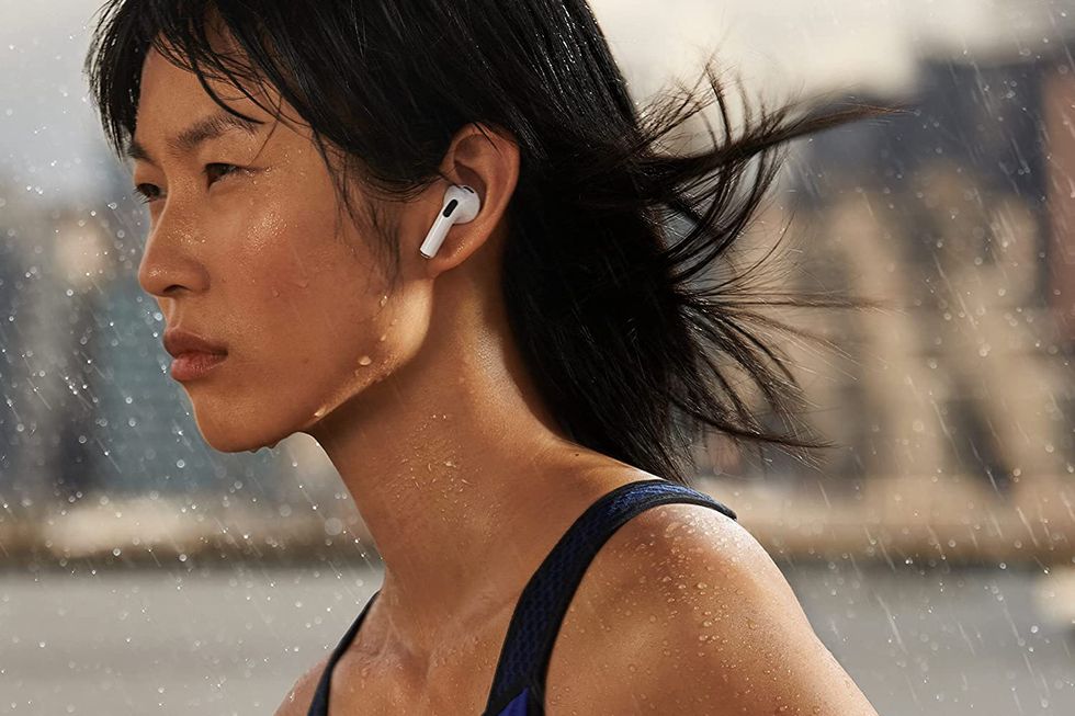 athlete wearing apple airpods 3rd generation in rain