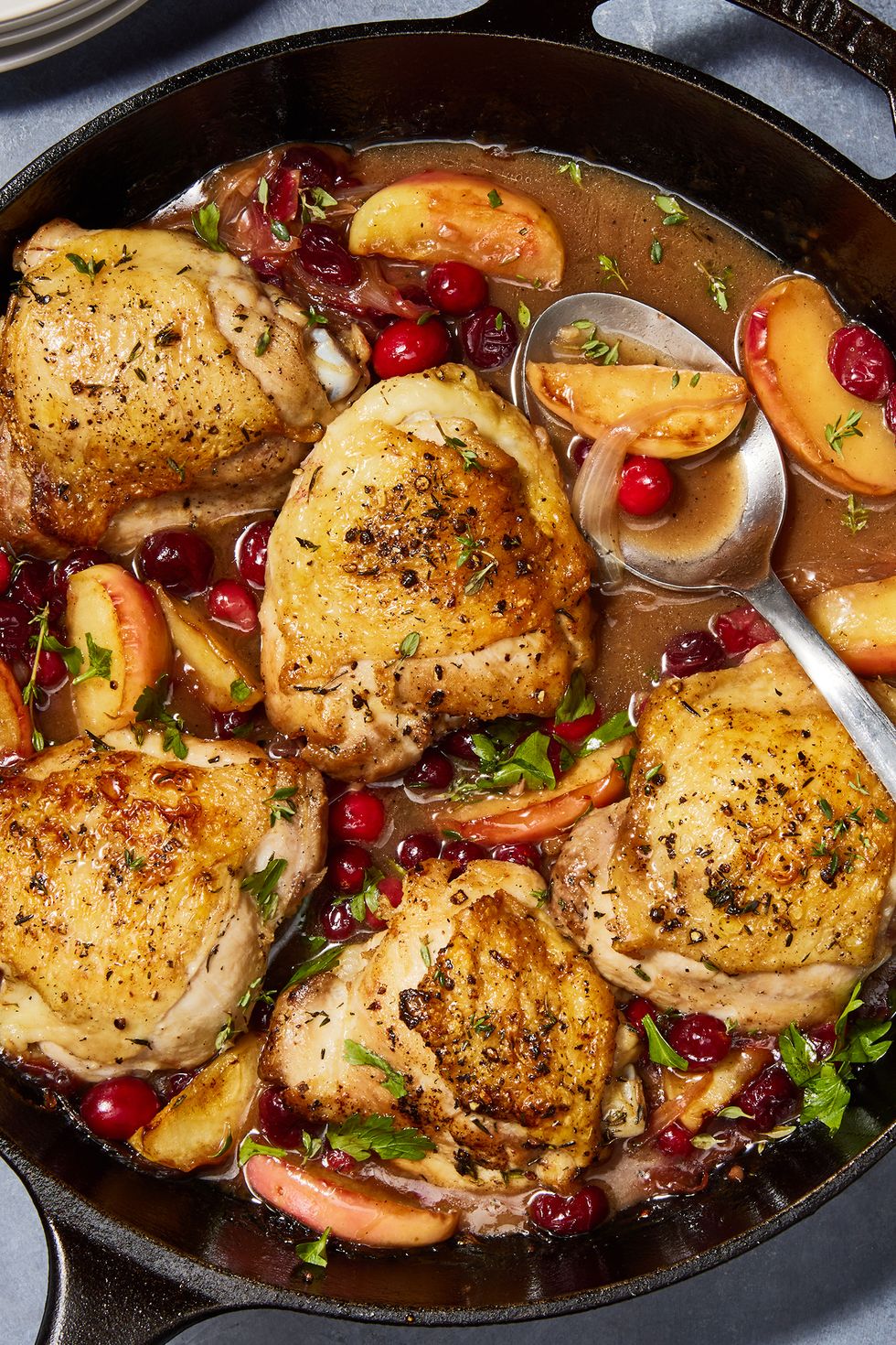 apple cranberry roasted chicken in a skillet