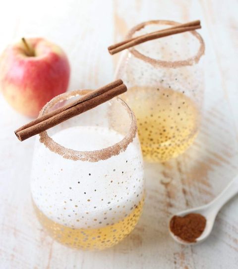 apple cider champagne cocktail with cinnamon in spoon