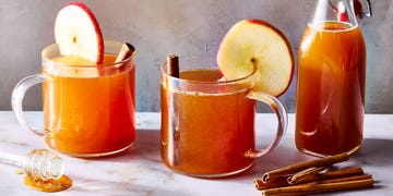 apple cider hot toddy with an apple garnish and cinnamon stick