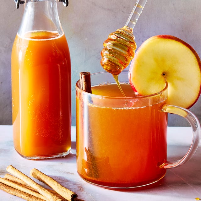 apple cider hot toddy with an apple garnish and cinnamon stick
