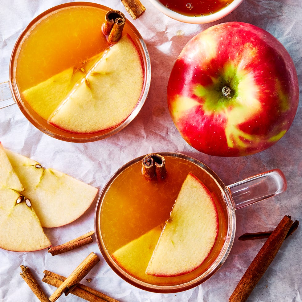 apple cider hot toddy with an apple garnish and cinnamon stick