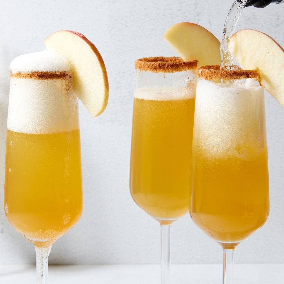 apple cider mimosas with apple slices as garnish