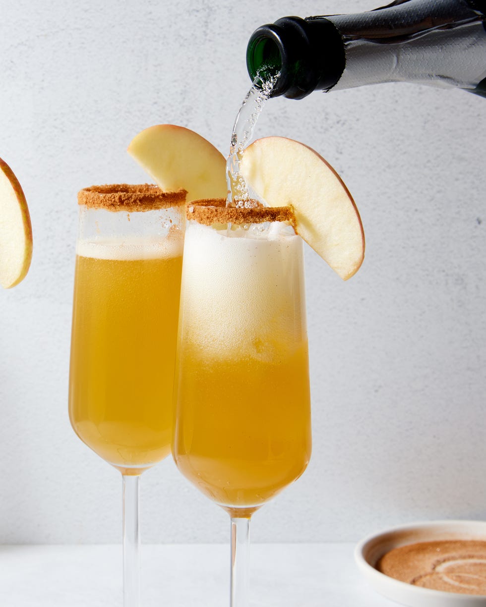 apple cider mimosas with a cinnamon rim and apple slices