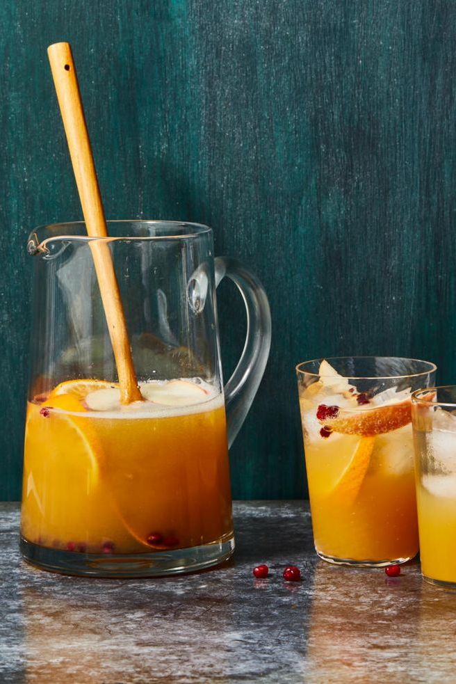 a pitcher of apple cider sangria with two glasses on the side