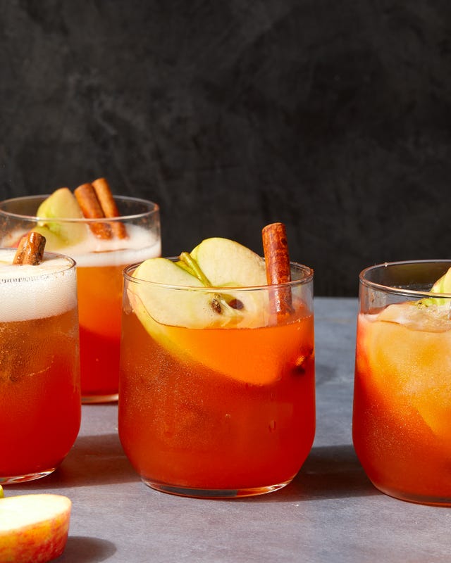 apple cider spritzes garnished with apples and cinnamon sticks