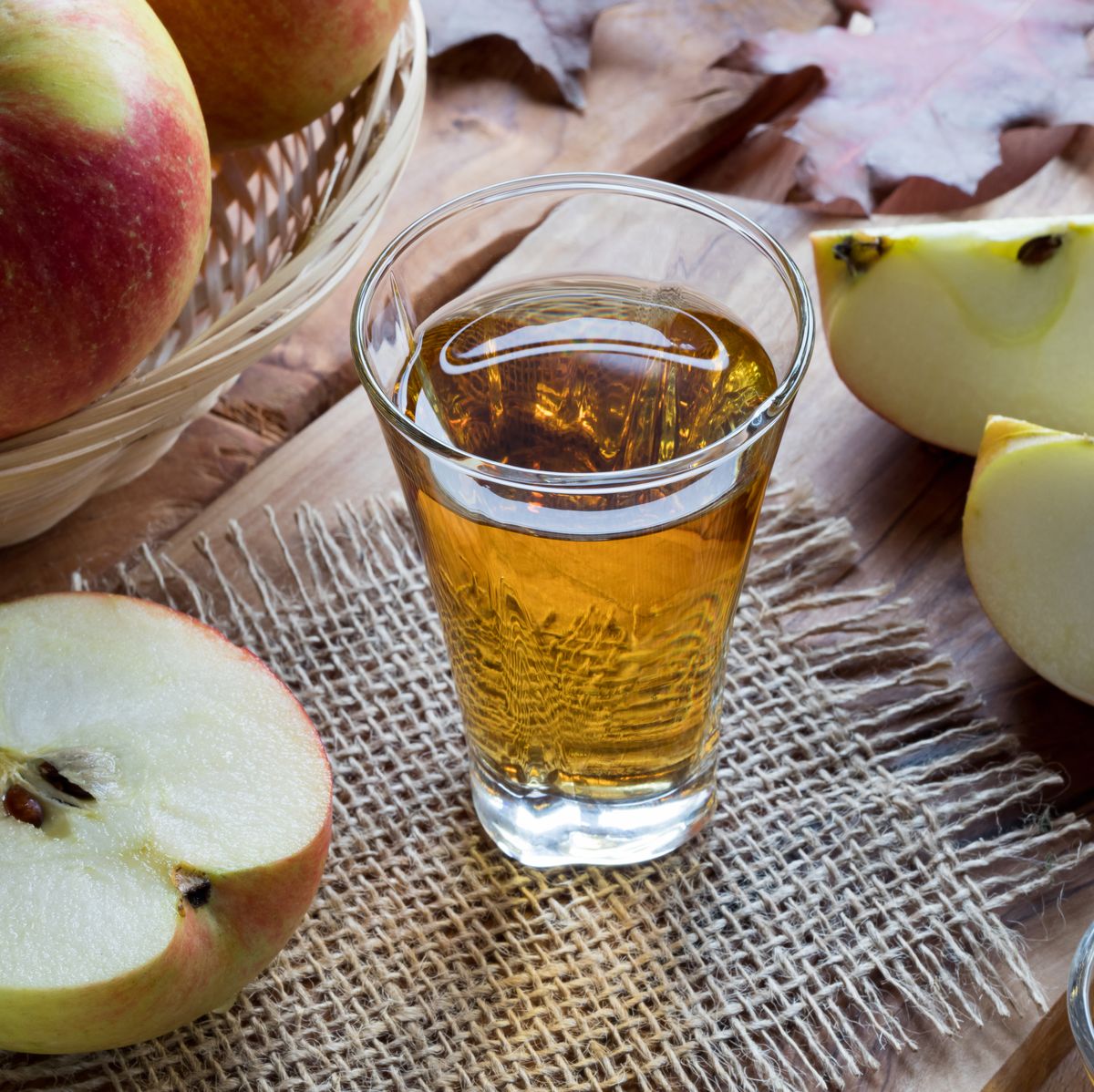 Apple cider vinegar in a glass on a wooden table