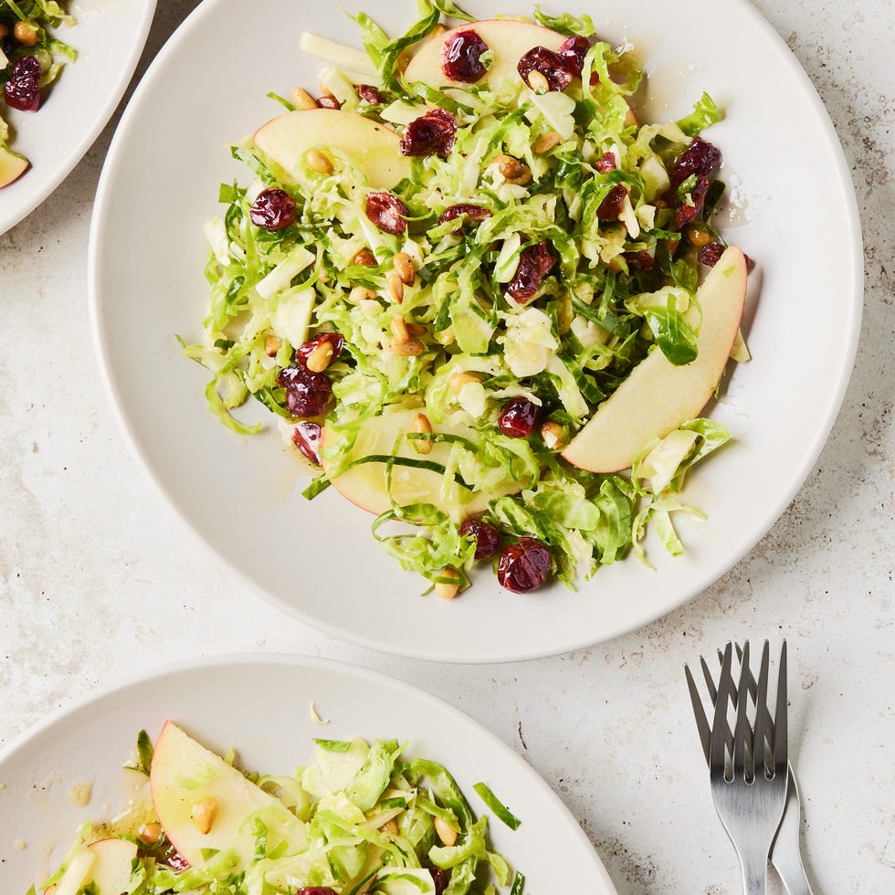 apple cranberry brussel sprout salad in a white bowl