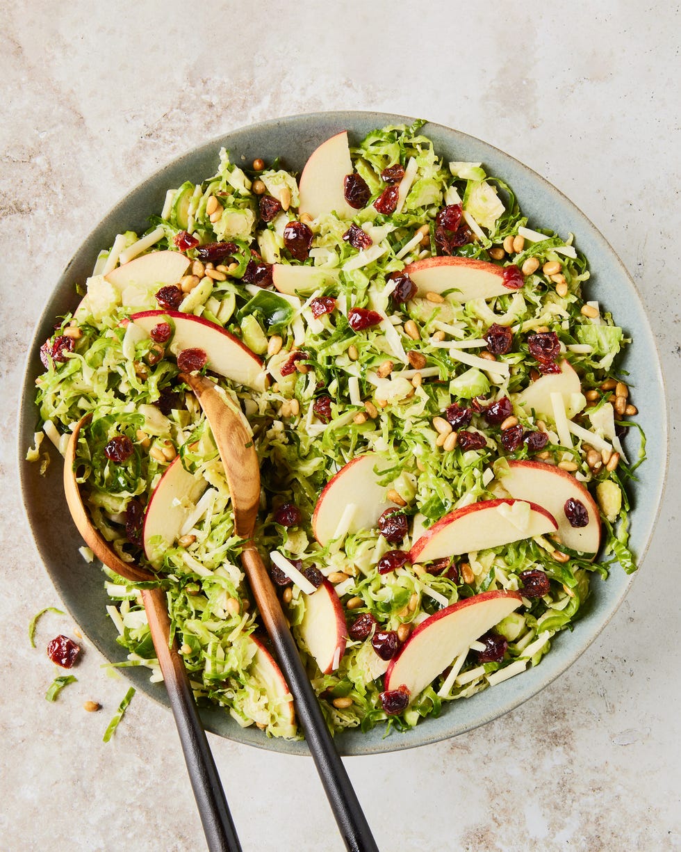 apple cranberry brussel sprout salad in a white bowl