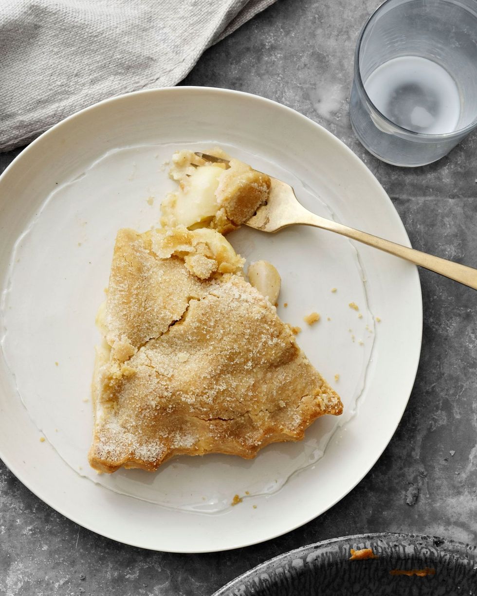 a slice of all american apple pie on a plate with a fork