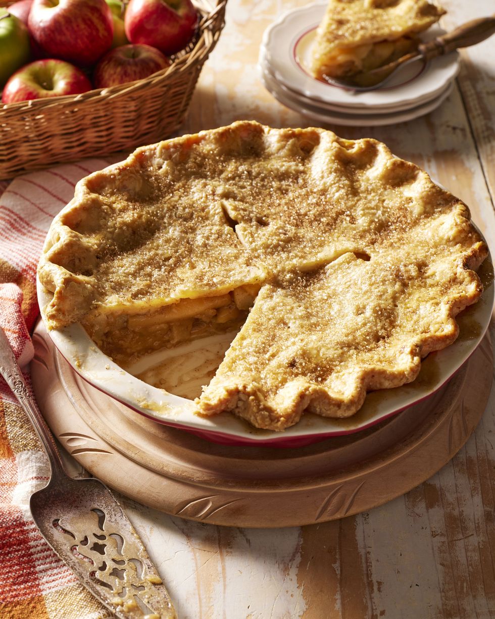 brown butter apple pie in a pie plate with a pie server