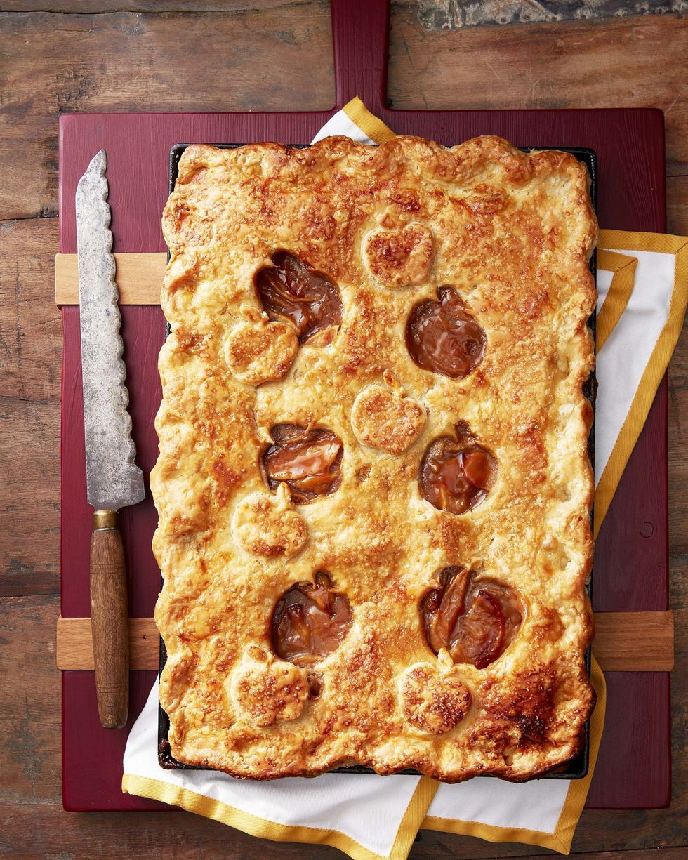 caramel apple slab pie in a sheet pan with apple shaped cut outs in the top crust