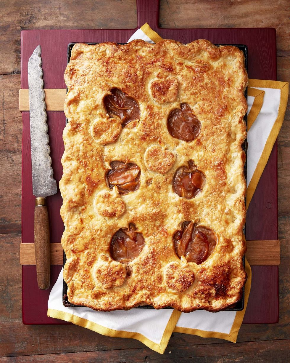 caramel apple slab pie in a sheet pan with apple shaped cut outs in the top crust