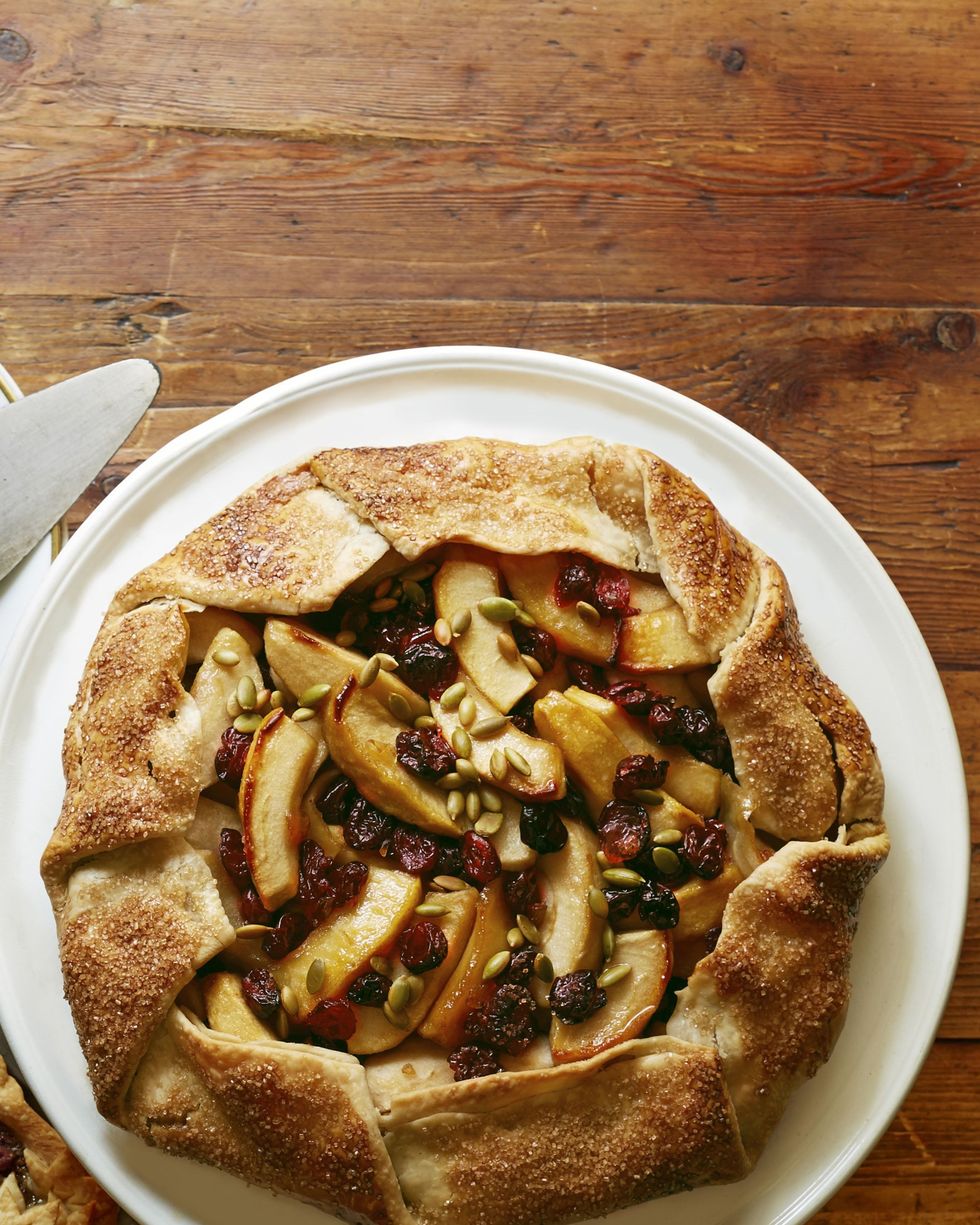 apple crostata with dried cherries cranberries and pepitas on a white plate