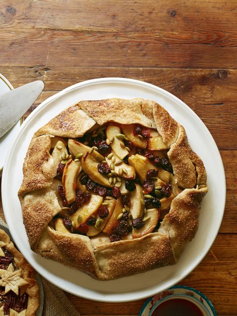 apple crostata with dried cherries cranberries and pepitas on a white plate