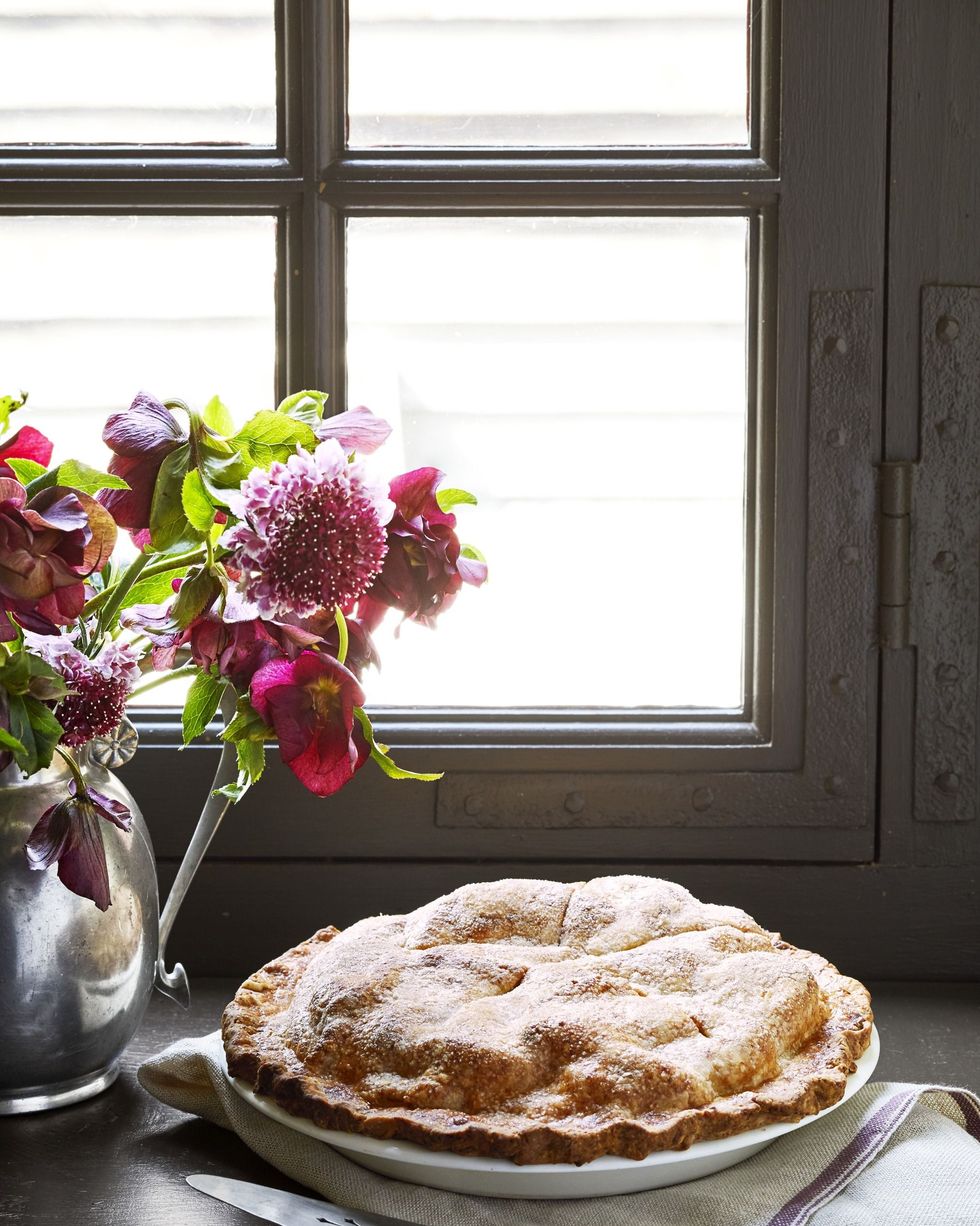 apple dessert recipes double crust apple cheddar pie in a pie plate on a window sill