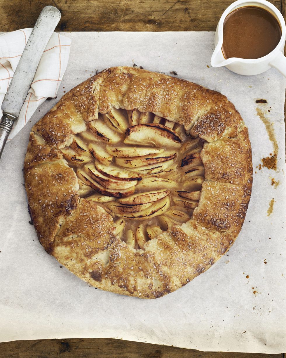 rustic apple galette on a parchment lined serving board