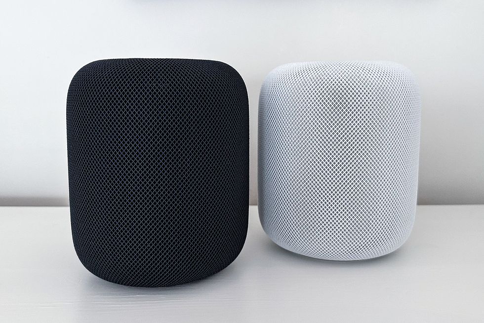 apple homepod black and white model sitting next to each other on a counter