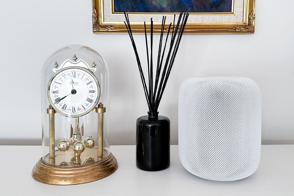 apple homepod 2nd generation sitting on a counter with other decor items
