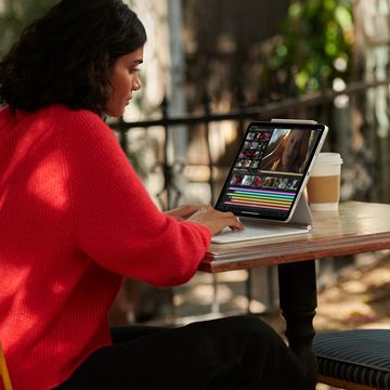 woman using ipad pro on outdoor table