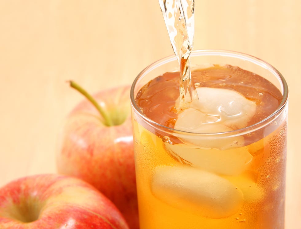 apple juice being poured into a glass