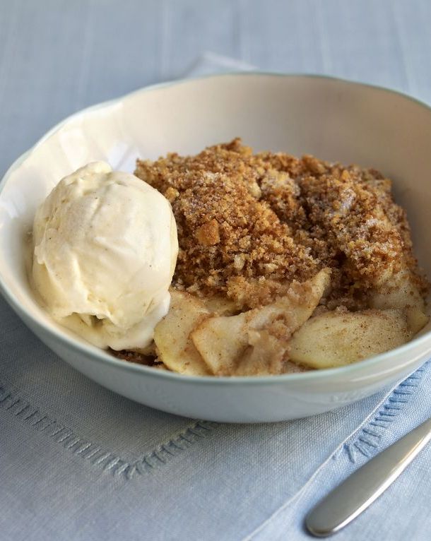 Apple Brown Betty in a bowl, spoon nearby