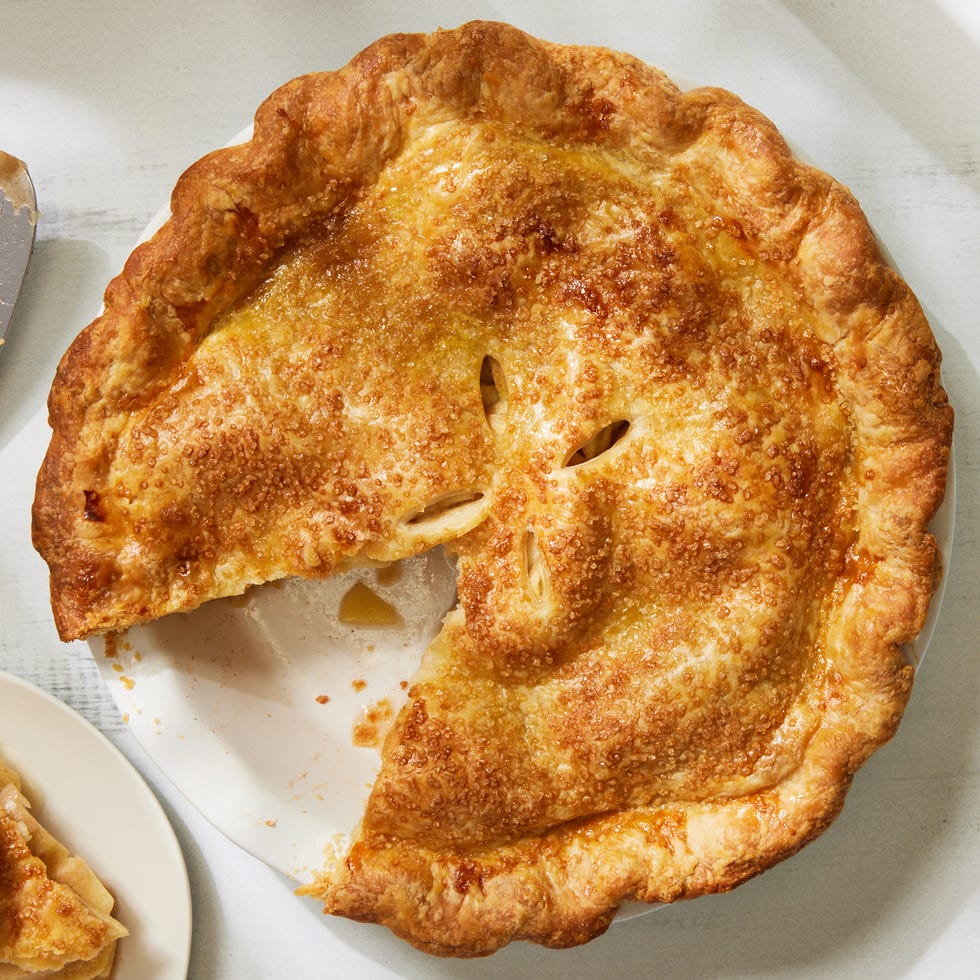 an apple pie with a slice cut out