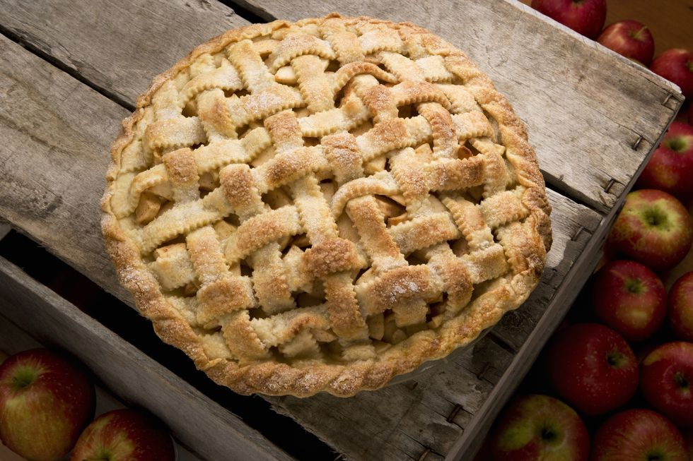 apple pie with lattice crust on a rustic wooden crate