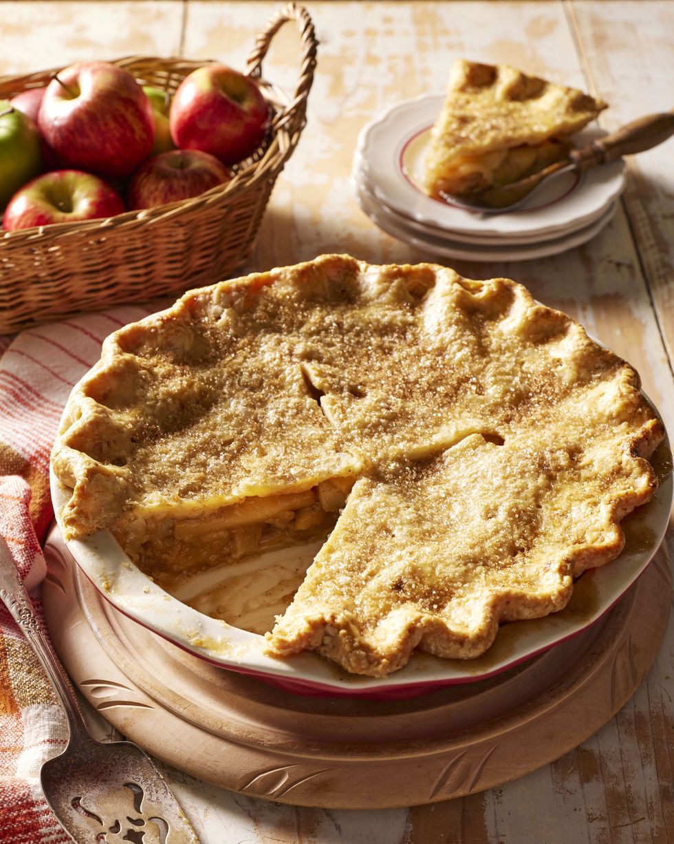 brown butter apple pie in a pie plate with a slice taken out