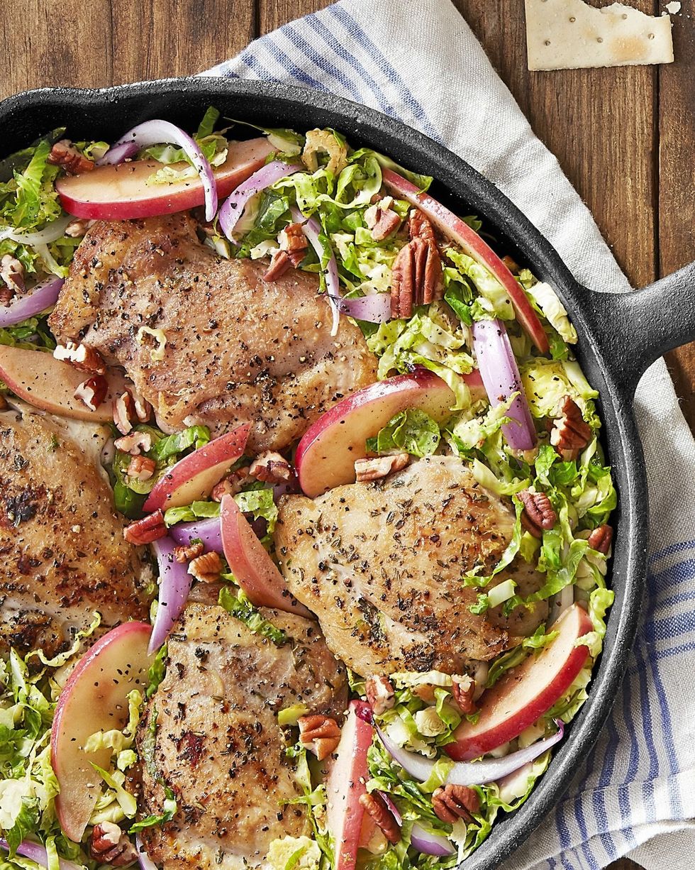 chicken with brussels sprouts and apples in a cast iron skillet