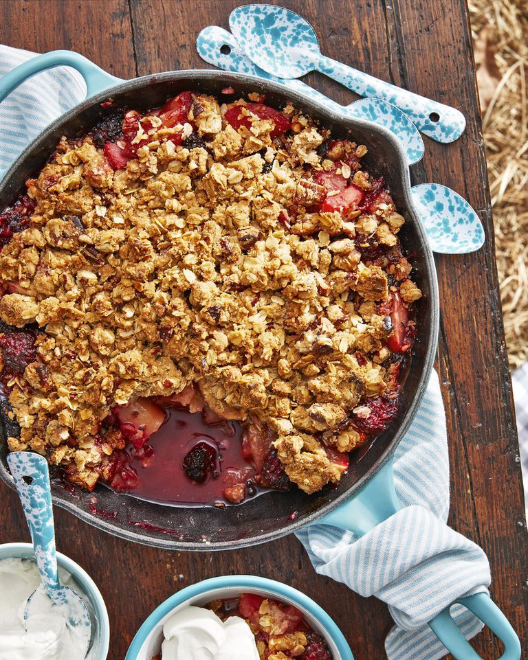 apple blackberry crumble with sour cream whip in a cast iron skillet