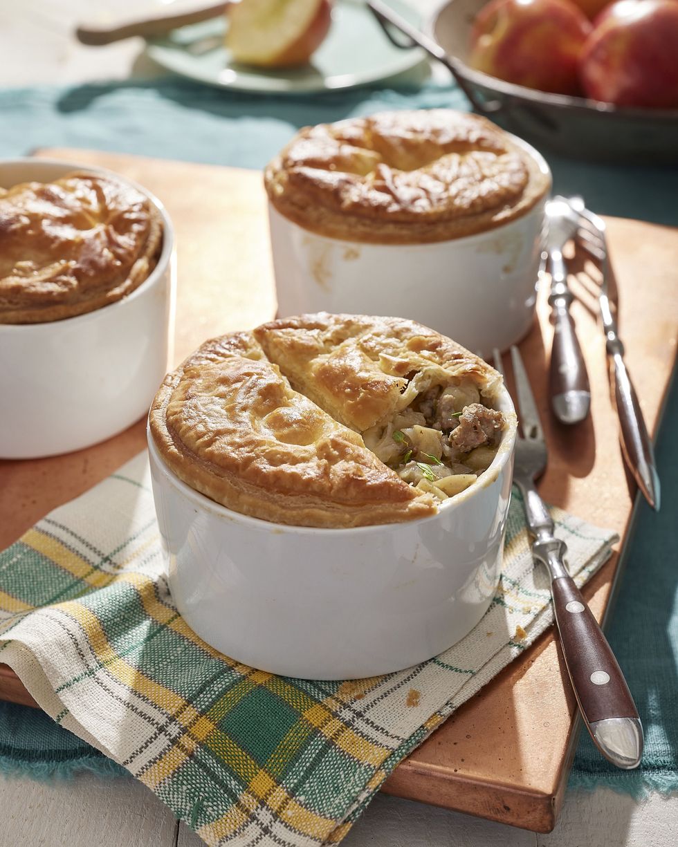 individual sausage and apple pies made in white ramekins