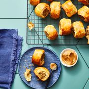 apple sausage rolls on a metal rack with mustard