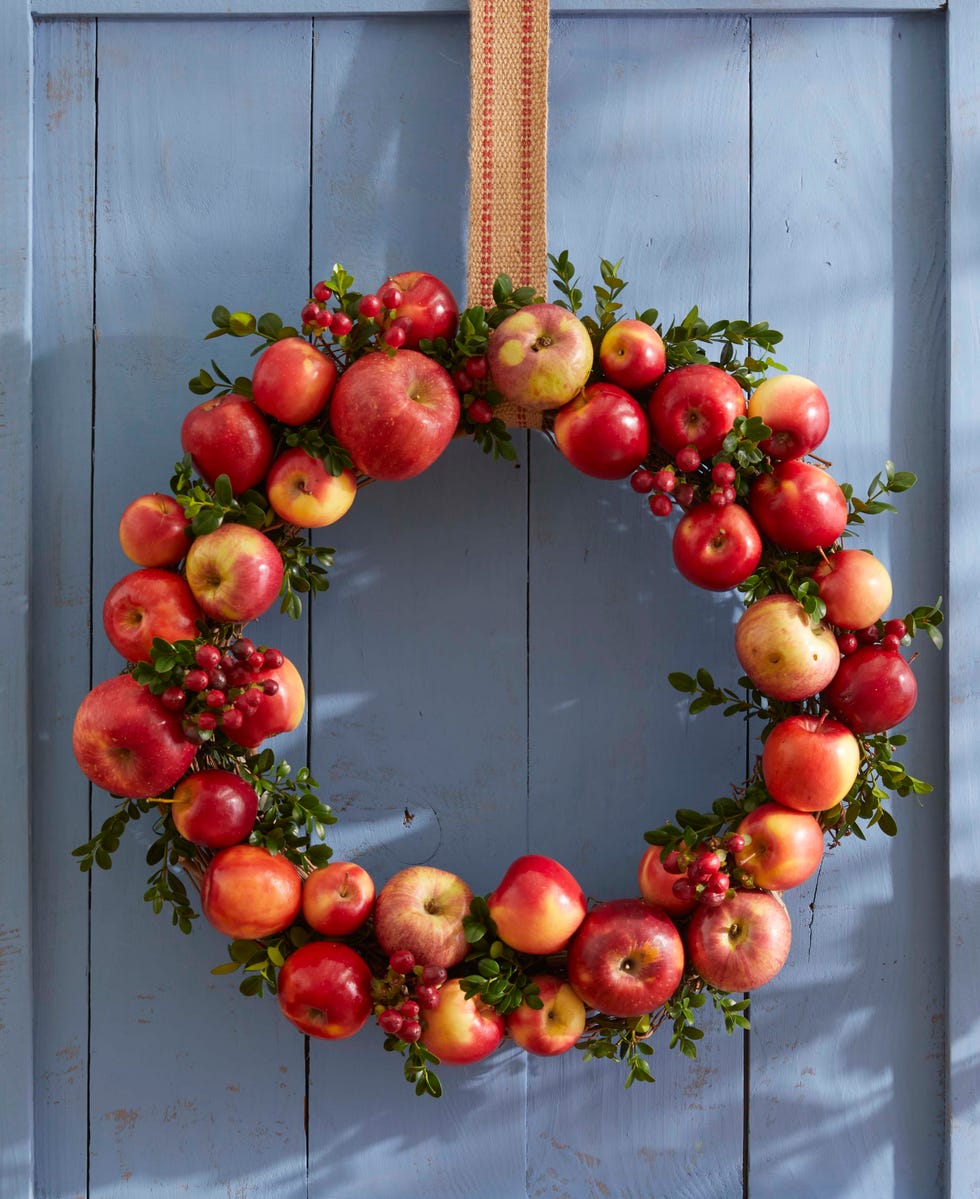 a wreath made from apples and boxwood