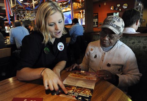 GLENDALE, CO--NOVEMBER 11TH 2010-- Applebee's restaurant waitress, Nicole Thomason, left, points out the menu to U.S. Army Veteran Nurse, Dolores Collins, for a free lunch at Applebee's restaurant at 410 S. Colorado Blvd Thursday, Veterans Day, November 1