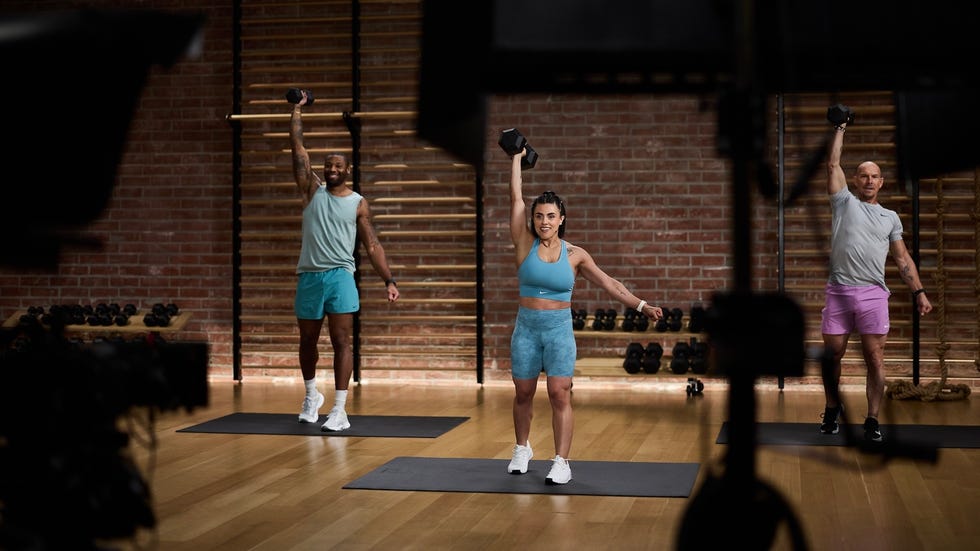 fitness group training session featuring participants working out with dumbbells