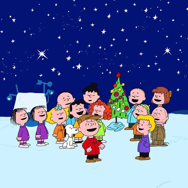 scene from charlie brown christmas special of peanuts characters caroling in the snow at night
