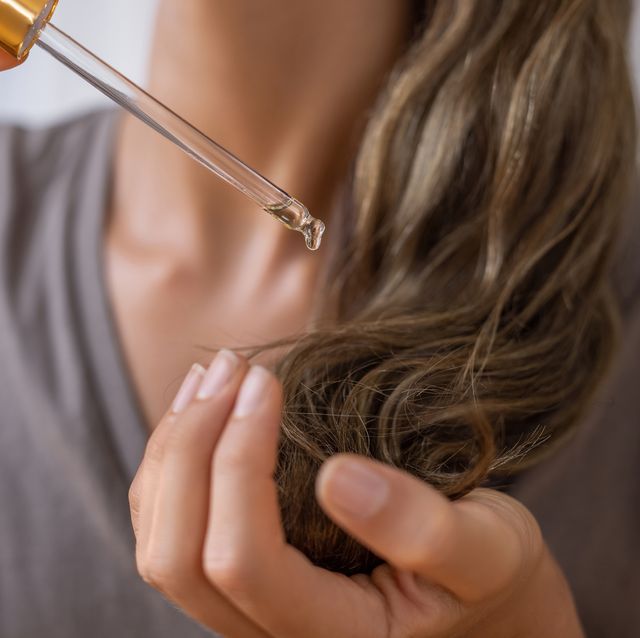 applying natural organic essential oil on hair