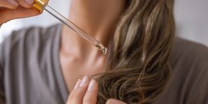 applying natural organic essential oil on hair
