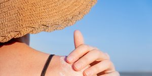 applying suntan cream on the beach