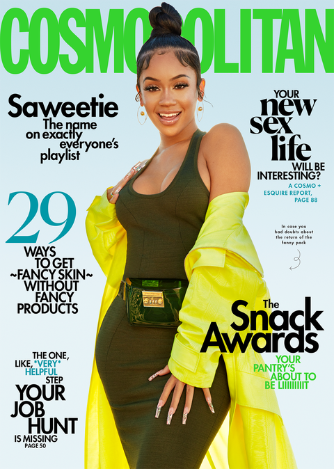 april 2021 cosmopolitan cover of singer saweetie, wearing a dress, coat, and fanny pack, in front of sky backdrop