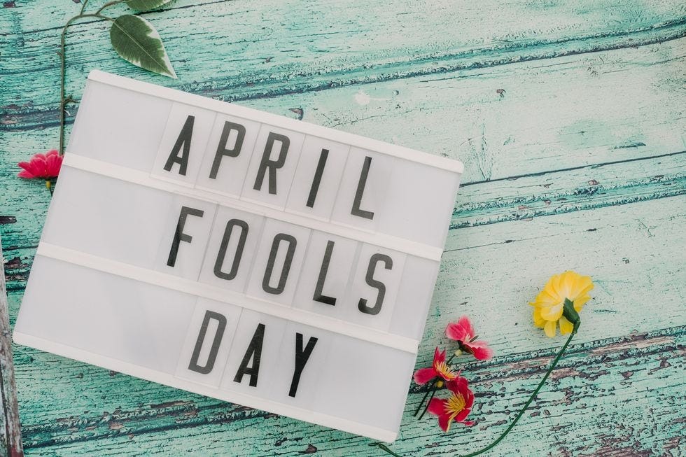 phrase april fools day in lightbox on rustic bead board background painted turquoise