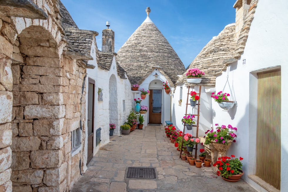 traditional whitewashed trulli houses in the town of alberobello, a unesco world heritage site, in metropolitan city of bari, apulia region, southern italy a trullo plural, trulli is a traditional apulian dry stone hut with a conical roof