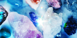 different crystals arranged on a blue background
